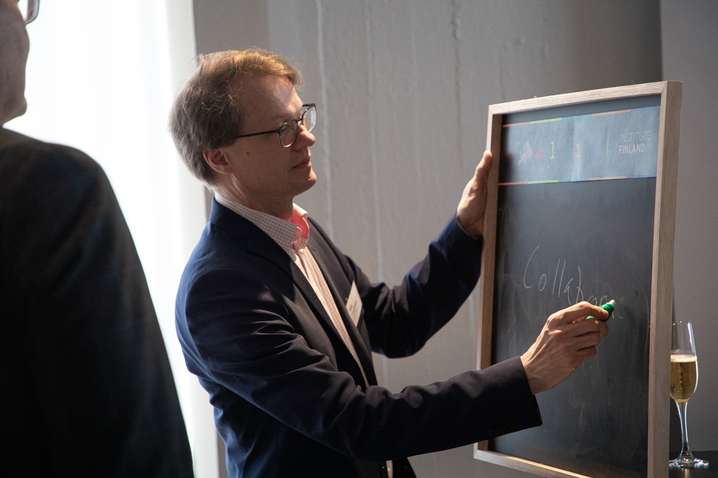 Man writing with chalk on a blackboard