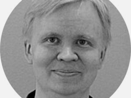 Portrait of a blond-haired smiling man.