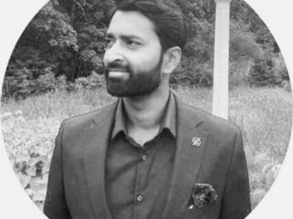 Portrait of a dark-haired man in a suit.