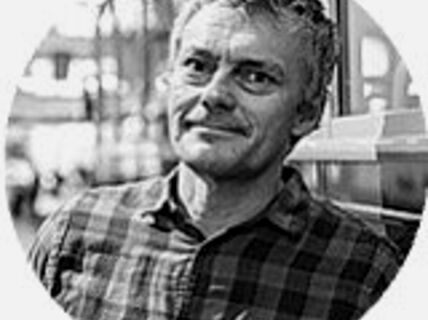 Portrait of a man in plaid shirt.