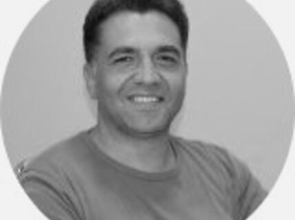 Portrait of a smiling dark-haired man.