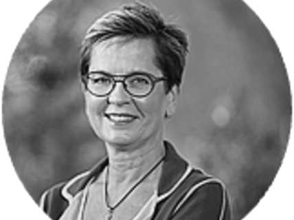 Portrait of a smiling woman with glasses.