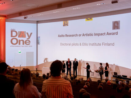 People on stage in an auditorium