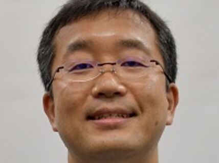 Headshot of a man with glasses