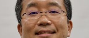 Headshot of a man with glasses