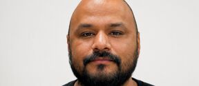 Headshot of man wearing black shirt