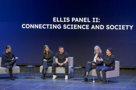 Five people seated on sofas on stage with text in background: ELLIS Panel II Connecting Science and Society