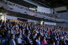Many people seated in two tiers in the Logomo auditorium