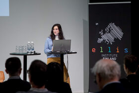 Woman standing at podium with laptop