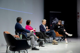 Four people seated in chairs