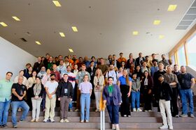 A large group of people standing on a wide staircase in a group photo