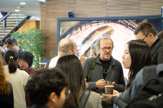 Crowd of people standing and talking in a lobby