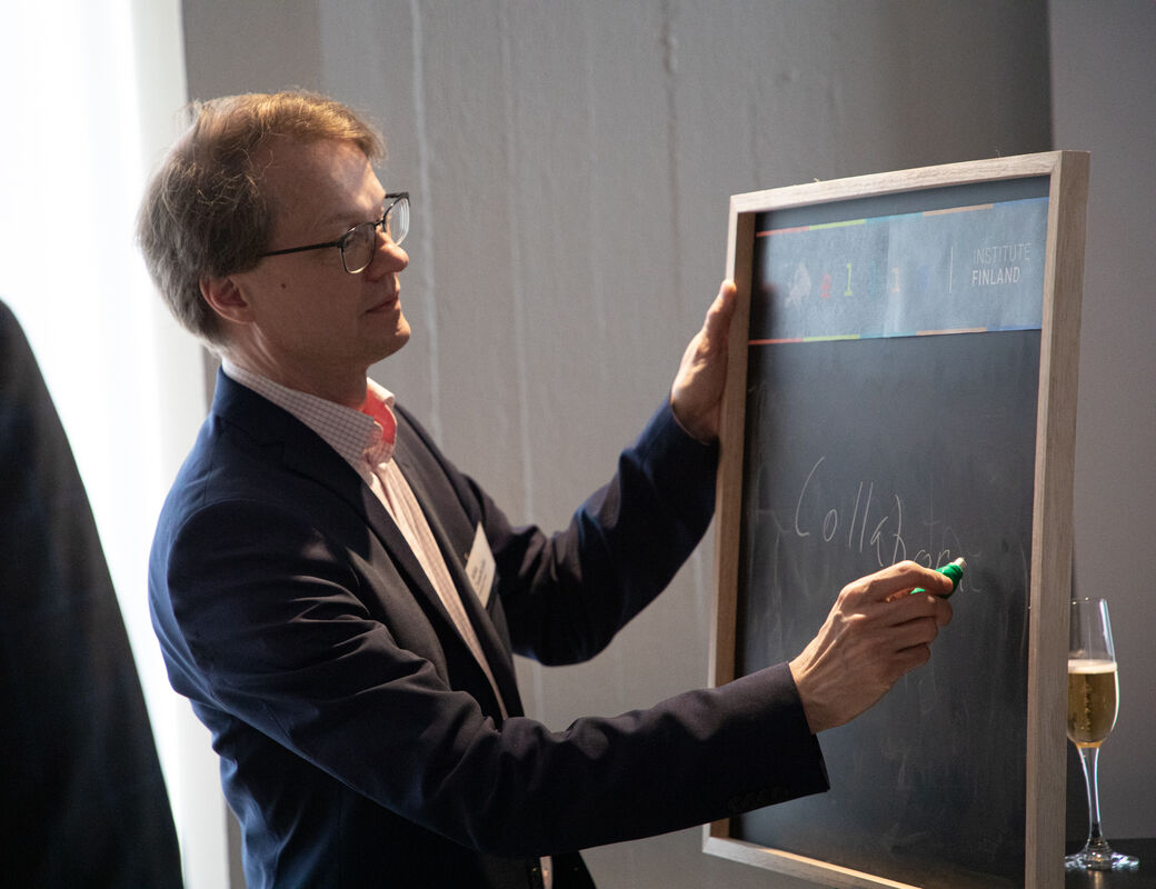 Man writing with chalk on a blackboard